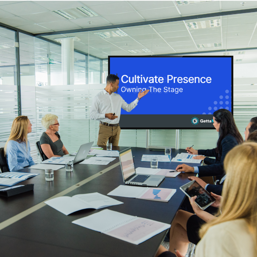 A man introducing the meeting module video on a screen in a conference room of employees.