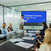 A man introducing the meeting module video on a screen in a conference room of employees.