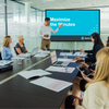 A man introducing the meeting module video on a screen in a conference room of employees.